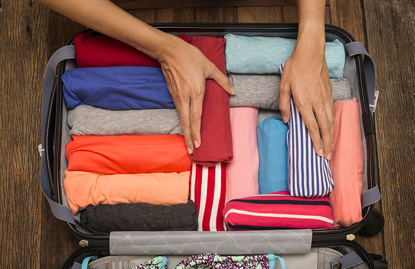 The best travel tip for luggage packing is rolling your clothes to save space